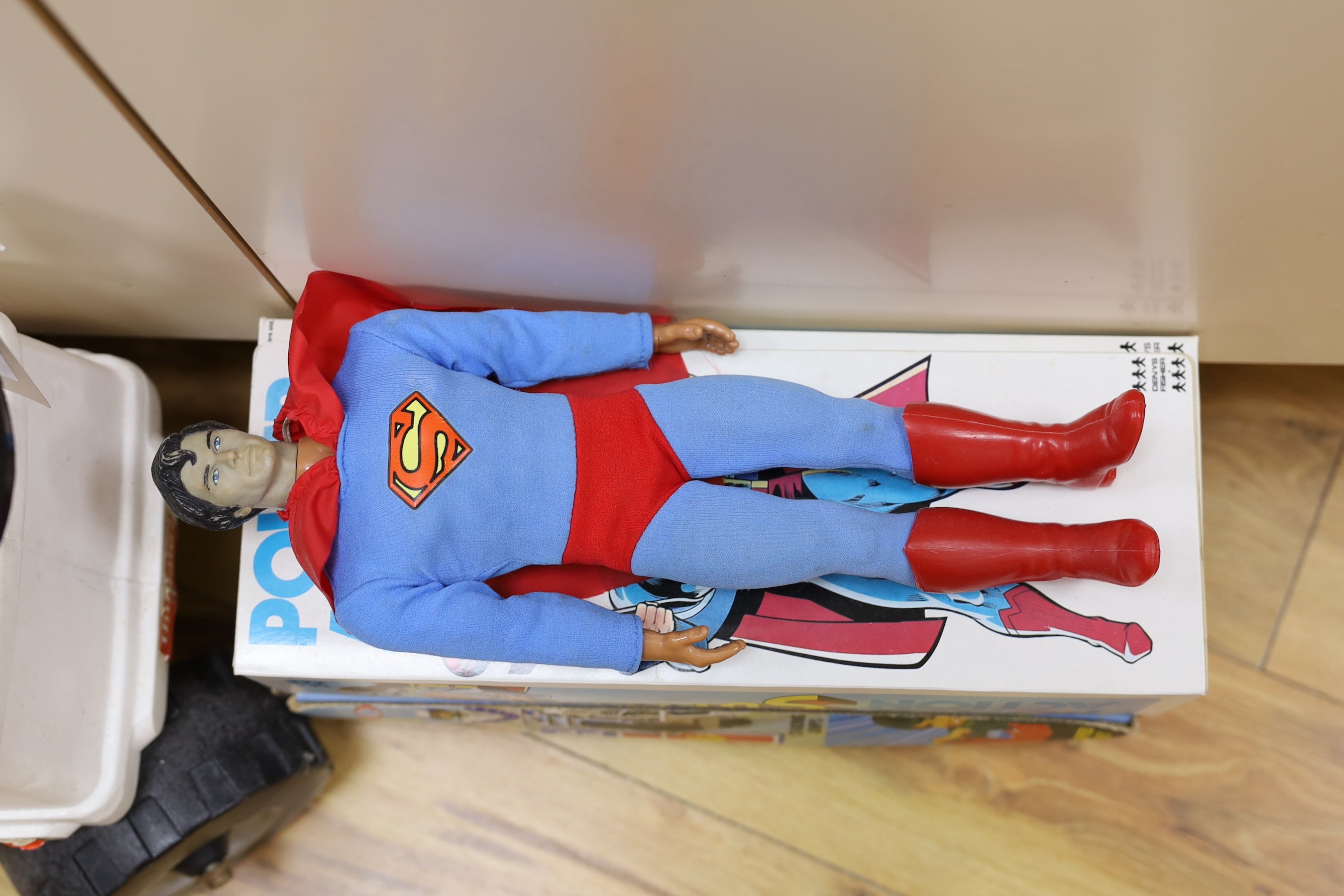 A Denys Fisher Superman, rare in original box, another unboxed, a Unigate milk float with bottles, and a boxed Evel Knievel Stunt Cycle